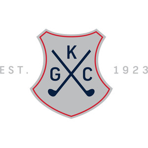 Kooyonga Golf Club logo: A grey shield edged in red bearing two navy golf clubs crossed in a saltire, with a navy letter K above the crossing and G and C to its left and right, and EST. to the left of the shield and 1923 to the right in pale grey capitals.