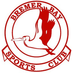 Bremer Bay Golf Club logo: A red double-ring circular badge lettered BREMER BAY in red capitals around the top, enclosing a red pelican in flight facing left with a long deep outlined bill and throat pouch, its head drawn back on a folded neck, its broad wings raised with ragged fingered tips and its legs trailing behind, above a red ribbon banner lettered SPORTS CLUB.