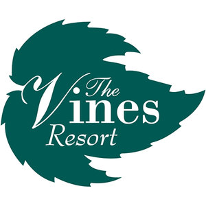 The Vines Golf Course logo: A dark teal leaf-shaped device with jagged lobed edges carrying white lettering that reads The in script across the top, Vines in lowercase serif letters led by an oversized swash capital V, and Resort in italic script beneath.