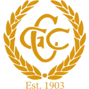 Corowa Golf Course logo: A gold laurel wreath, open at the top and closed by a small gold dot at its base, encircles an ornate interlocking C, G and C monogram in gold, with Est. 1903 in gold serif lettering underneath.