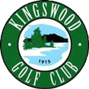 Kingswood Golf Club logo: A dark-green circular seal, 'KINGSWOOD' arched in white capitals above and 'GOLF CLUB' below, with a small white rivet dot at each side, enclosing a painted lake scene of dark evergreen pines and a wooded headland across pale blue water, the year 1915 in navy at the foot of the scene.