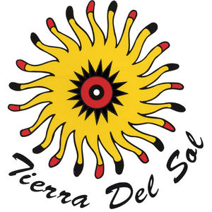 Tierra Del Sol Golf Club logo: A folk-art sun with about twenty wavy yellow rays tipped alternately in red and black, around a black starburst enclosing a red disc with a black ring and a white dot at its center; 'Tierra Del Sol' in black brush script curving below.