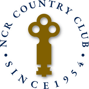 NCR Country Club logo: A gold antique key standing upright with a three-lobed bow, encircled by the navy words NCR COUNTRY CLUB above and SINCE 1954 below, separated by navy dots.