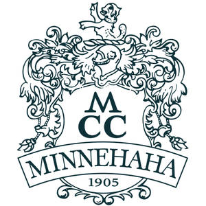 Minnehaha Country Club logo: A dark green heraldic crest: a rampant lion crest standing on a helm draped in elaborate scrolling acanthus mantling, over a plain shield lettered 'M C C' in serif capitals, above a ribbon banner reading MINNEHAHA with the founding year 1905 beneath it.