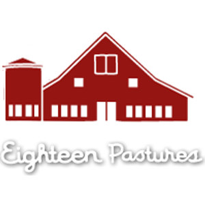 Eighteen Pastures logo: A dark red gambrel-roofed barn with white windows and an attached red silo on the left, above the name Eighteen Pastures in white cursive script edged by a grey drop shadow that keeps it legible on white.