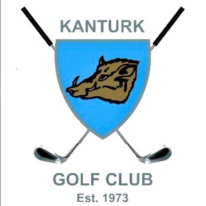 Kanturk Golf Club logo: A light blue shield with a brown wild boar's head in profile facing left, crossed black-shafted golf clubs with silver heads behind it, 'KANTURK' in slate blue capitals above, and 'GOLF CLUB' with 'Est. 1973' in grey below.