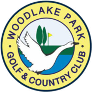 Woodlake Park Golf Club logo: A yellow circular badge outlined in navy reading WOODLAKE PARK above and GOLF & COUNTRY CLUB below in navy capitals, enclosing a white swan flying right over a blue lake with two dark green upright trees and a small yellow flag on a green fairway.