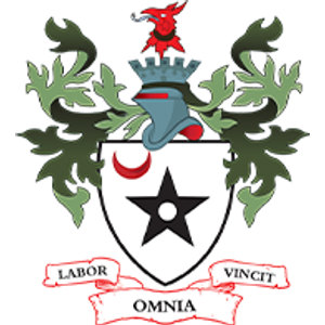 Ashton-Under-Lyne Golf Club logo: A white shield bearing a black five-pointed star pierced by a white roundel with a red crescent above it to the left, below a blue-gray helm topped by a battlemented mural crown, with dark and pale green oak-leaf mantling spreading either side, a red boar's head at the summit, and a white scroll edged in red reading LABOR OMNIA VINCIT.