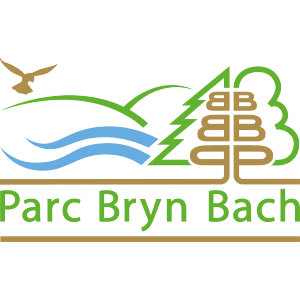 Bryn Bach Park Golf Club logo: A brown bird flying up to the left above green rolling hills and two blue wavy water lines, beside a green pine and a green rounded tree outline filled with stacked gold letter B shapes, above 'Parc Bryn Bach' in green lettering over a brown bar.