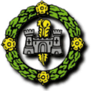 Flint Golf Club logo: A grey stone castle with two towers and a central arched gateway, a large yellow key standing behind it, inside a green laurel wreath ring set with four yellow flowers at top, bottom, left and right.