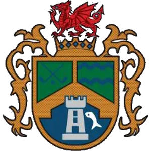 Vale of Llangollen Golf Club logo: A red Welsh dragon standing on a blue and gold coronet above a gold-edged shield split into three panels — a green panel with two crossed silver golf clubs at upper left, a green panel with three blue wavy lines at upper right, and a blue lower half holding a grey battlemented tower beside a white leaping fish — framed by gold scrollwork mantling.