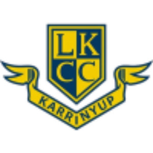 Lake Karrinyup Country Club logo: A navy shield outlined in gold and quartered in gold and navy bearing the letters L, K, C and C in alternating gold and navy block capitals, set over a gold ribbon banner with feathered wing tips at each end lettered KARRINYUP in navy.