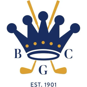 Bowral Golf Club logo: A navy blue crown with five points tipped by round finials and five gold dots across its band, resting on a navy outlined oval ring, with two gold golf clubs crossed behind it so their shafts rise above the crown and their heads splay below, the navy serif letters B and C set either side and G beneath, and EST. 1901 in small navy capitals underneath.